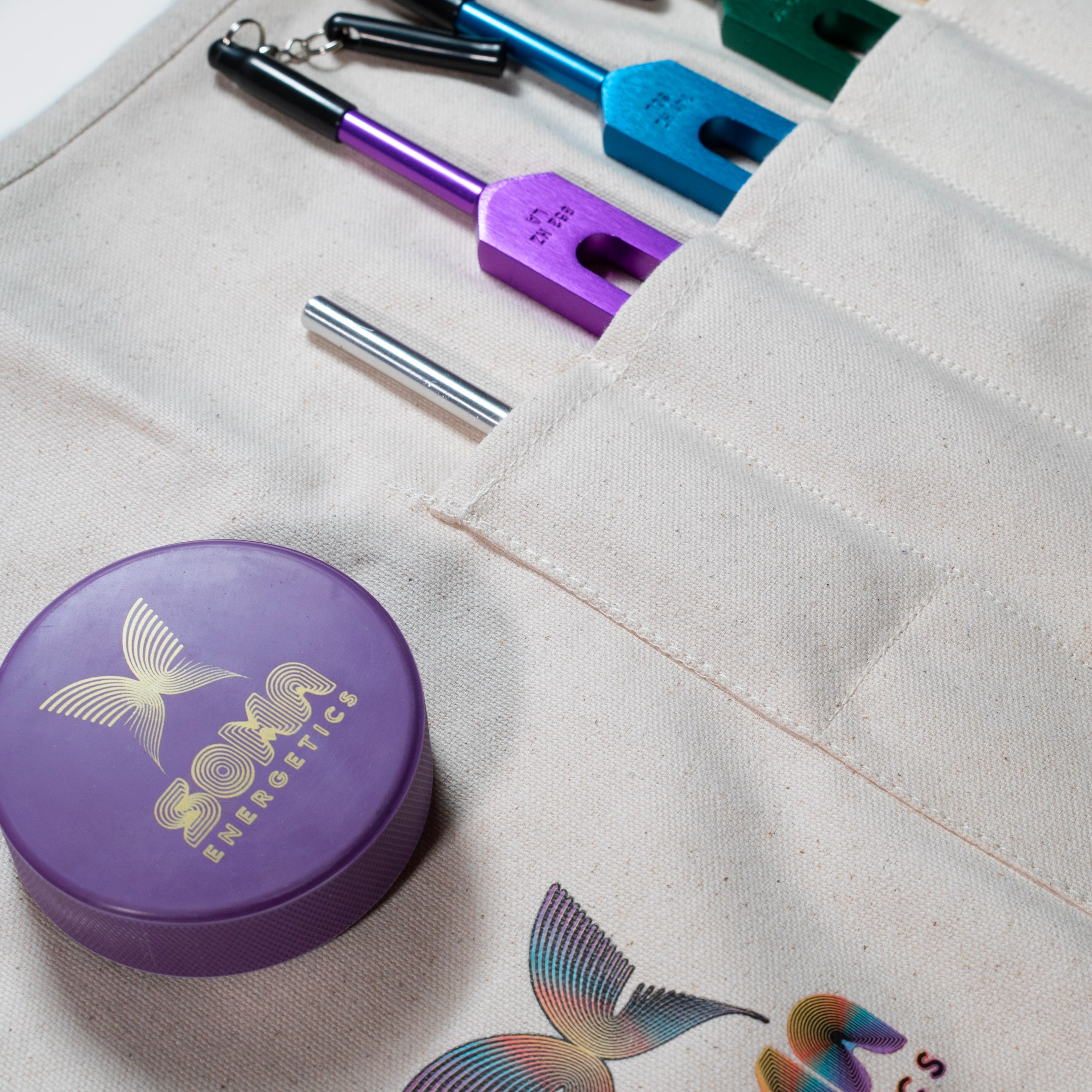 Closeup of Cotton Canvas Tuning Fork Apron Roll Bag with attached tuning fork sounding puck. 